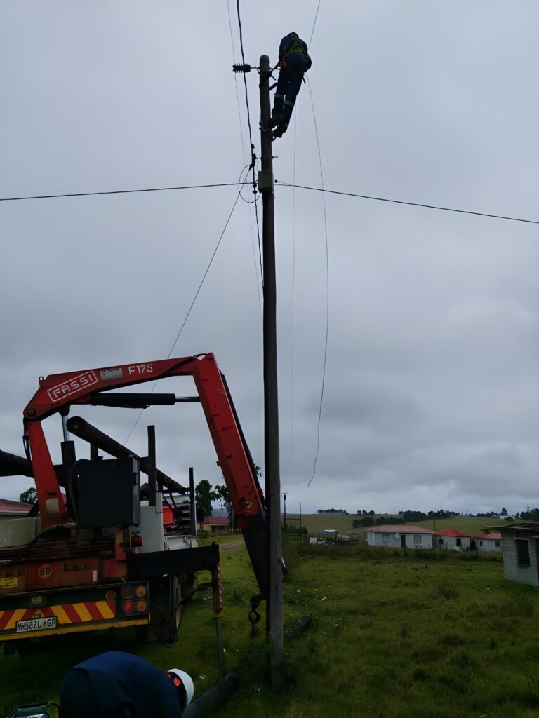 a person working on a electrical street pole