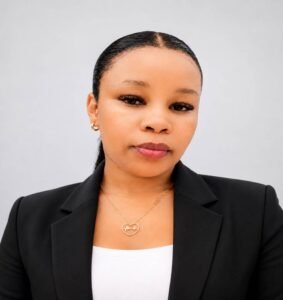 a young lady wearing a black blazer & white t shirt