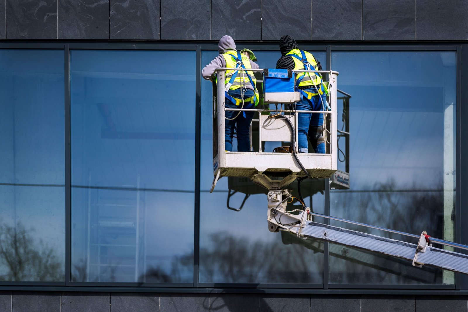 two men painting a building