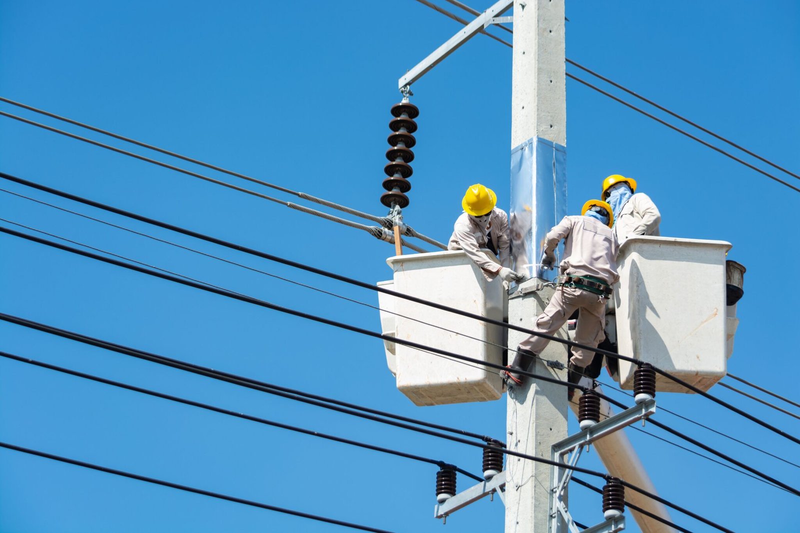Three Engineers working on a street pole