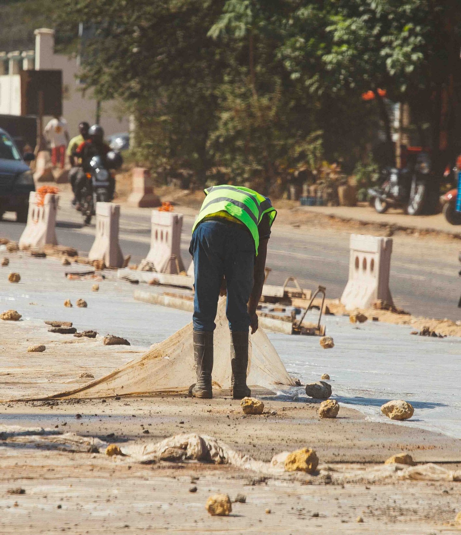 a construction worker bending down